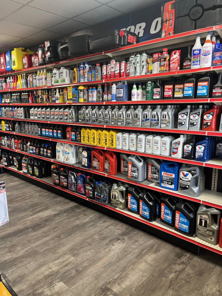 Retail shelves stocked with motor oils and automotive fluids